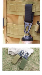 Heavy-duty tactical carabiner with nylon webbing strap hanging on an outdoor backpack.