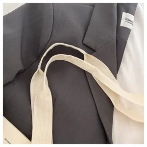 Detailed view of large capacity travel bag strap, durable fabric and sturdy canvas handle.