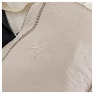 Detailed view of lightweight nylon travel bag, casual beige shoulder luggage bag texture.
