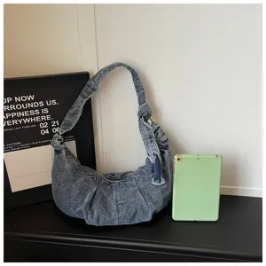 Blue denim hobo shoulder bag with a stylish knotted strap and a spacious interior design