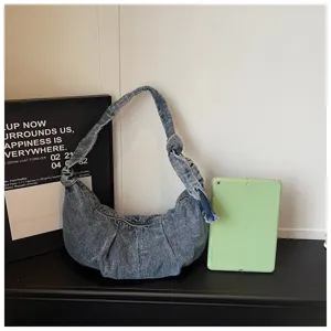 Large capacity denim shoulder bag shown next to a tablet for clear size comparison