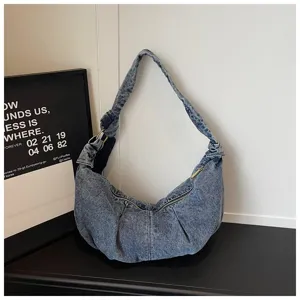 Large capacity denim hobo bag in a casual minimalist indoor setting
