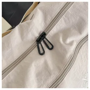Close-up view of durable travel duffel bag zipper and lightweight fabric texture details.
