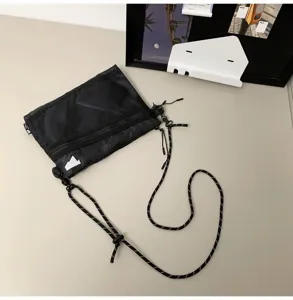 Black Japanese street style mesh crossbody bag with adjustable cord shoulder strap