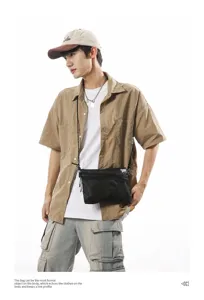 Male model wearing a black Japanese streetwear style nylon tactical crossbody bag.