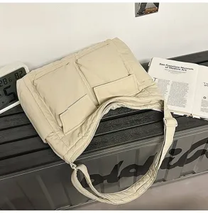 Beige vintage canvas messenger bag detail showing large utility pockets and durable fabric