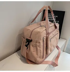 Large capacity pink travel bag with multiple pockets for fitness and business trips