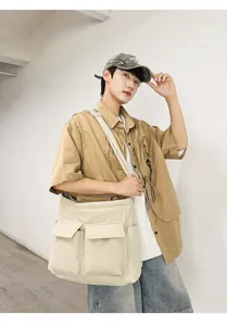 Close-up of a retro beige canvas messenger bag showing its large capacity and pocket design