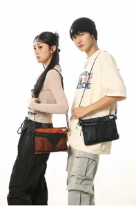 Fashion models wearing Japanese workwear messenger bags for outdoor street style