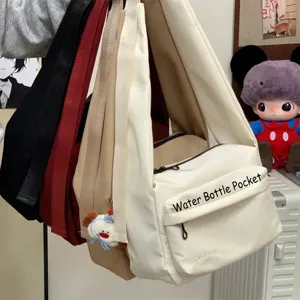 Minimalist canvas crossbody bag featuring a wide strap and dedicated water bottle pocket