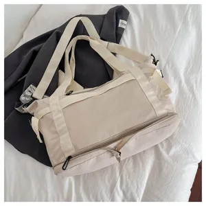 Close-up view of the beige travel duffel bag showing durable fabric texture and strap design.