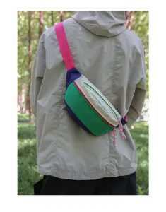 Model wearing a colorful dopamine-style crossbody fanny pack outdoors in nature.