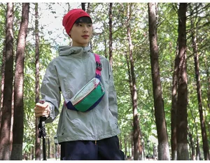 Outdoor lifestyle shot of a vibrant multi-color sporty crossbody chest bag for hiking