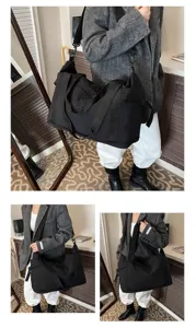 Detailed view of the large black travel duffel bag worn by a model, showing daily commuting use.