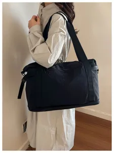 Large capacity travel duffle bag for women, lightweight overnight luggage shoulder bag.