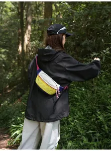 Detailed shot of a colorful outdoor cycling fanny pack worn in a forest setting