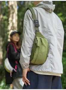 Detailed view of the green grid-textured sporty chest bag worn in an outdoor forest setting