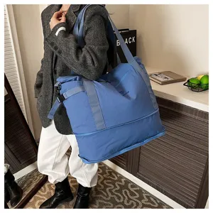 Close-up detail shot of the large blue travel duffel bag showing durable nylon material and straps.
