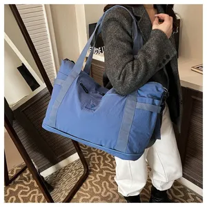 Large capacity blue travel shoulder bag detail, lightweight daily commuter tote for women.