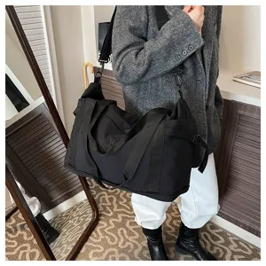 Large capacity black nylon travel duffel bag with shoulder strap for commuting and short trips.