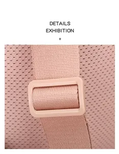 Macro view showing the breathable mesh texture and adjustable strap buckle of a pink backpack