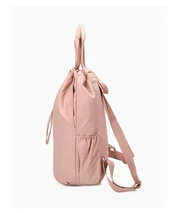 Side view of lightweight pink nylon travel backpack with adjustable straps and handle