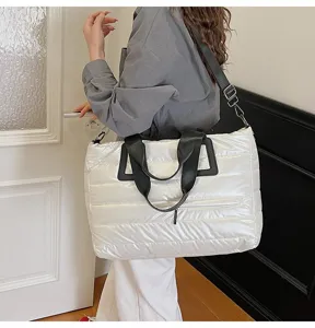 Large white quilted puffer tote bag shown as a shoulder bag in a lifestyle setting