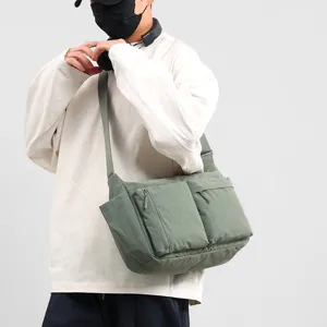 Full view of casual sage green messenger bag with functional multi-pocket design