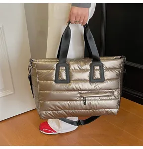 Large champagne metallic puffer tote bag shown as a casual shoulder bag in detail
