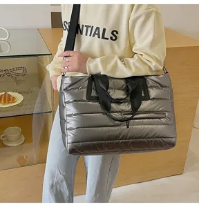 Lifestyle view of a silver puffer tote bag with large capacity and quilted texture.