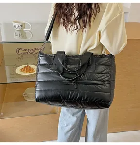 Large capacity black puffer tote bag with quilted design shown on model shoulder