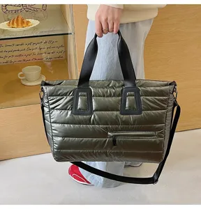 Lifestyle shot of large metallic olive green puffer tote bag with quilted design