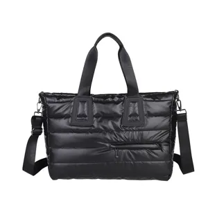 Large capacity black puffer tote bag with quilted design and adjustable shoulder strap