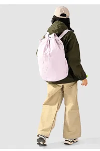 Back view of a large light purple nylon drawstring backpack worn by a model in casual outdoor gear