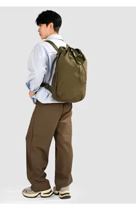 Side view of olive green lightweight nylon backpack with large capacity and drawstring