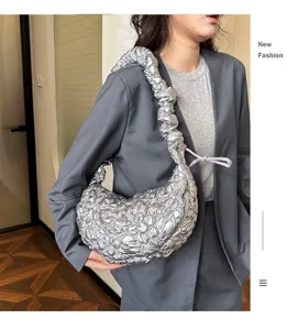 Stylish silver metallic pleated cloud hobo bag shown being worn by an Asian model