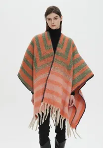 Front view of thick bouclé yarn faux mohair jacquard striped poncho with tassels