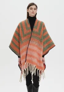 Close-up detail of thickened loop yarn jacquard striped poncho with soft fringe trim
