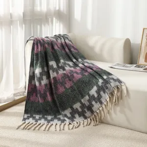Detail shot of a faux mohair ethnic jacquard blanket with elegant tassel edges