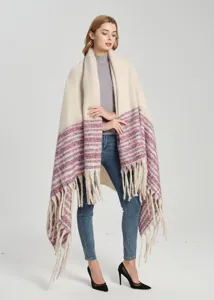 Close-up detail of thick bouclé yarn oversized shawl featuring colorful stripes and tassels