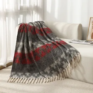 Faux mohair bouclé ethnic striped blanket with tassels on a cozy white sofa