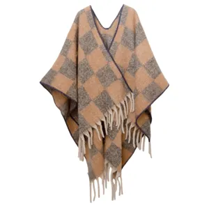Gros plan sur un poncho en mohair épais à carreaux avec des détails de franges stylées