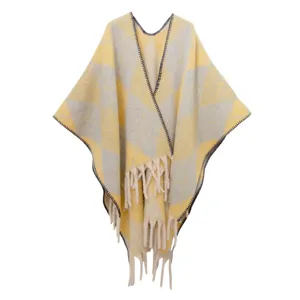 Vista dettagliata di scialle jacquard spesso con motivi a rombi gialli e nappe a frangia