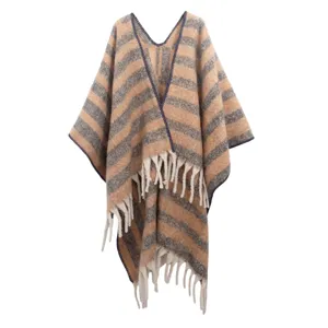 Detail showing the thick striped texture and elegant fringe of this bouclé yarn poncho