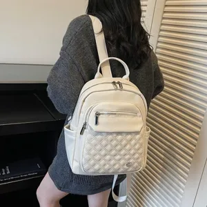 Back view of a minimalist white soft leather backpack with quilted pattern design