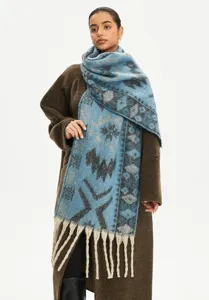 Close-up view of a blue faux mohair ethnic jacquard winter scarf featuring long tassels