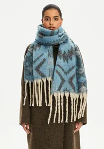 Detailed view of blue ethnic jacquard scarf with faux mohair texture and long fringes