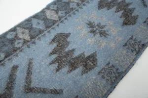 Close-up of blue faux mohair ethnic jacquard scarf showing soft texture and geometric pattern