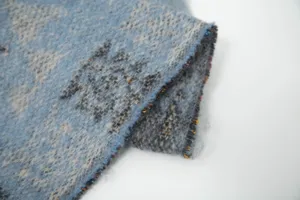 Macro detail of soft imitation mohair jacquard fabric with blue ethnic knit pattern