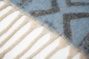 Detailed close-up of blue ethnic jacquard scarf with soft fringe tassels and mohair feel